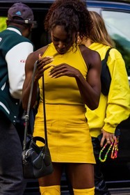 bag, black bag, color, courreges bag, courreges look, Dina Asher Smith, leather bag, leather skirt, mini skirt, skirt, top, yellow skirt, yellow top, street style, jonathan paciullo, FW, frenchystyle, fashion week, PFW, PARIS, SPRING SUMMER 2022, SS 22, vertical, atmosphere details